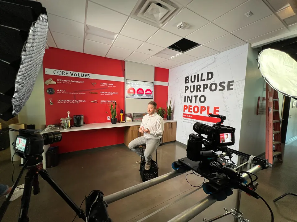 Wide view of the testimonial interview set with key light and two cameras